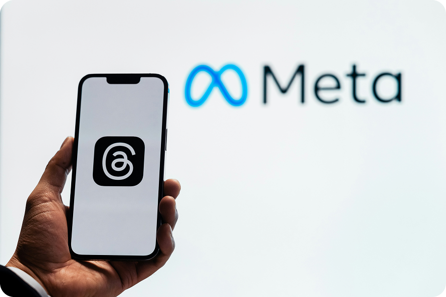 A man in a suit holding an iPhone displaying the "Thread" logo, with the Meta logo visible in the foreground.