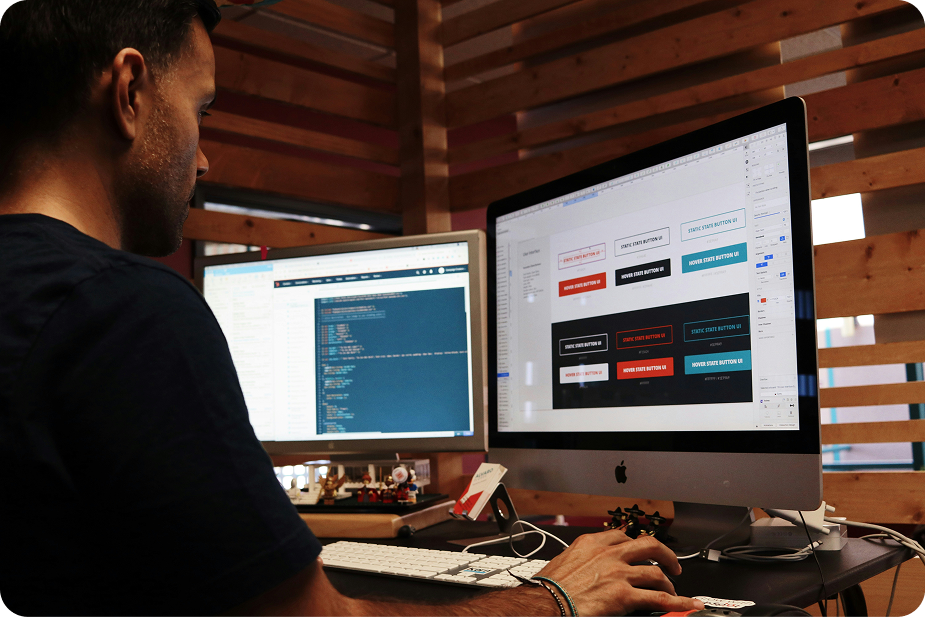 Male web developer in Johor Bahru reviewing website performance data or code on a desktop computer.